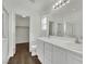 Bathroom with dual sinks, vanity, framed mirror, and shower with glass enclosure at 6525 Bismark Hills St, North Las Vegas, NV 89084