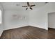 A spacious bedroom with three windows, ceiling fan, and wood-look flooring at 6525 Bismark Hills St, North Las Vegas, NV 89084