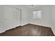 A simple bedroom with sliding closet and wood-look flooring at 6525 Bismark Hills St, North Las Vegas, NV 89084