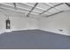 Spacious two-car garage with automatic door, water heater, and ample room for storage at 6525 Bismark Hills St, North Las Vegas, NV 89084