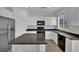 Bright kitchen with white cabinets, stainless steel refrigerator, and black appliances at 6525 Bismark Hills St, North Las Vegas, NV 89084