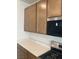 Modern kitchen with stone countertops, light cabinets, stainless steel microwave, and a gas range at 6574 Tumoulin St, Las Vegas, NV 89148
