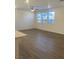 Spacious living room with hardwood floors, a ceiling fan, and plenty of natural light at 6574 Tumoulin St, Las Vegas, NV 89148