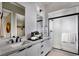 Modern bathroom with dual sinks, white marble countertops, and glass-enclosed shower at 664 Agate Bridge St, Las Vegas, NV 89138