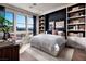 Cozy bedroom with large windows, hardwood floors, modern shelving, and stylish accents at 664 Agate Bridge St, Las Vegas, NV 89138