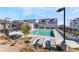 Community pool with ample lounge chairs, surrounded by manicured landscaping in a modern community setting at 664 Agate Bridge St, Las Vegas, NV 89138