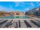 Community pool with plenty of lounge chairs, perfect for relaxation and enjoying the sunshine at 664 Agate Bridge St, Las Vegas, NV 89138