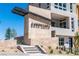 Contemporary building entrance featuring stone architecture and desert landscaping at 664 Agate Bridge St, Las Vegas, NV 89138