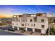 Modern townhome complex with garage parking and rooftop terraces, showcasing modern architecture and community living at 664 Agate Bridge St, Las Vegas, NV 89138