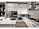 Sleek kitchen featuring stainless steel appliances, marble countertops, hardwood floors, and modern lighting at 664 Agate Bridge St, Las Vegas, NV 89138