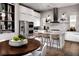 Modern kitchen with stainless steel appliances, marble countertops, hardwood floors, and sleek cabinetry at 664 Agate Bridge St, Las Vegas, NV 89138