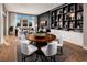 Open-concept living and dining space with a wooden table, hardwood floors, and stylish decor at 664 Agate Bridge St, Las Vegas, NV 89138