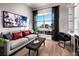 Modern living room with a comfortable couch, stylish decor, and a large window offering a bright, inviting space at 664 Agate Bridge St, Las Vegas, NV 89138