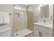 Bright bathroom featuring a neutral color palette, walk-in shower with a tiled surround, and a vanity with storage at 681 Pine Ridge Dr, Las Vegas, NV 89110