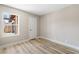 A bedroom space showcasing modern wood-look floors, neutral walls, base trim, and natural lighting at 681 Pine Ridge Dr, Las Vegas, NV 89110