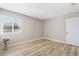 Bright bedroom featuring neutral walls and wood-style floors at 681 Pine Ridge Dr, Las Vegas, NV 89110