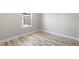 Empty bedroom featuring wood-look flooring, base trim, and natural light at 681 Pine Ridge Dr, Las Vegas, NV 89110