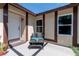 Inviting front porch featuring a cozy seating area and charming home number at 681 Pine Ridge Dr, Las Vegas, NV 89110