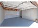 An expansive garage area with finished walls and flooring, and an automatic door mechanism at 681 Pine Ridge Dr, Las Vegas, NV 89110