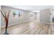 Bright and spacious living room with modern wood-style flooring and large windows at 681 Pine Ridge Dr, Las Vegas, NV 89110