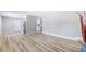 Open-concept living space with wood-style flooring that seamlessly connects to the kitchen at 681 Pine Ridge Dr, Las Vegas, NV 89110