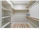 A sizable walk-in closet boasting built-in shelving and wood rods for optimal storage and organization at 681 Pine Ridge Dr, Las Vegas, NV 89110