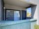 View of a gray balcony with sliding glass doors and a view of the community at 6955 N Durango Dr # 1038, Las Vegas, NV 89149