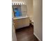 Bathroom featuring wood vanity, large mirror, and dark wood-look flooring at 6955 N Durango Dr # 1038, Las Vegas, NV 89149