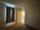 Bedroom with neutral carpet, curtains, and view to hallway and additional rooms at 6955 N Durango Dr # 1038, Las Vegas, NV 89149