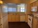 Bright kitchen features wood cabinetry, white appliances, and a stainless steel sink at 6955 N Durango Dr # 1038, Las Vegas, NV 89149