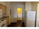 Kitchen with modern white appliances, wood cabinets, and dark wood-look floors at 6955 N Durango Dr # 1038, Las Vegas, NV 89149