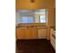 Kitchen featuring stainless steel sink, and modern white appliances, and wood cabinets at 6955 N Durango Dr # 1038, Las Vegas, NV 89149