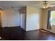 Bright living room featuring dark wood floors, a ceiling fan, and natural lighting at 6955 N Durango Dr # 1038, Las Vegas, NV 89149
