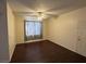 Living room with dark floors, ceiling fan, and curtains at 6955 N Durango Dr # 1038, Las Vegas, NV 89149