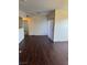 Spacious living room features hardwood floors, sliding glass door, and neutral paint at 6955 N Durango Dr # 1038, Las Vegas, NV 89149