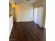 Spacious living room features hardwood floors, sliding glass door, and neutral paint at 6955 N Durango Dr # 1038, Las Vegas, NV 89149