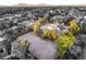 An aerial view of a modern home featuring a large yard, solar panels, and desert landscaping at 7185 Ranchito Cir, Las Vegas, NV 89120