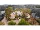 Aerial view of a beautiful home featuring mature landscaping, circular driveway, and tile roofing at 7185 Ranchito Cir, Las Vegas, NV 89120