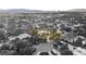An aerial view of a beautiful desert neighborhood highlighting a home with lush landscaping and a sparkling pool at 7185 Ranchito Cir, Las Vegas, NV 89120