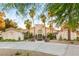 Elegant home with manicured landscaping, a circular driveway, fountain, and soaring palm trees at 7185 Ranchito Cir, Las Vegas, NV 89120