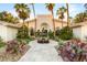 Charming home with a fountain, desert landscaping, lush greenery, and a circular driveway at 7185 Ranchito Cir, Las Vegas, NV 89120