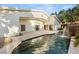 Luxury home exterior featuring a backyard pool with rock waterfall and patio at 7185 Ranchito Cir, Las Vegas, NV 89120