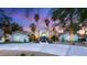 Elegant single-story home featuring a circular driveway, fountain, and lush, mature landscaping at 7185 Ranchito Cir, Las Vegas, NV 89120