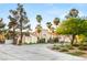 Attractive white home with palm trees and lush landscaping, complete with a circular driveway and fountain at 7185 Ranchito Cir, Las Vegas, NV 89120