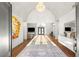 Spacious foyer with high ceilings, a chandelier, modern art, and hardwood floors leading into the home at 7185 Ranchito Cir, Las Vegas, NV 89120
