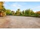 Expansive front yard with shrubbery and gravel space, offering potential for landscaping or other outdoor features at 7185 Ranchito Cir, Las Vegas, NV 89120