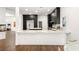 Bright kitchen with a bar and marble countertops and dark brown cabinets at 7185 Ranchito Cir, Las Vegas, NV 89120