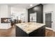 Modern kitchen featuring a large island with marble countertop and stainless steel appliances at 7185 Ranchito Cir, Las Vegas, NV 89120