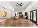 Spacious living room with hardwood floors, modern decor, and an open layout to the kitchen and dining area at 7185 Ranchito Cir, Las Vegas, NV 89120
