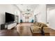 Living room features hardwood floors, a large television, and stylish decor at 7185 Ranchito Cir, Las Vegas, NV 89120